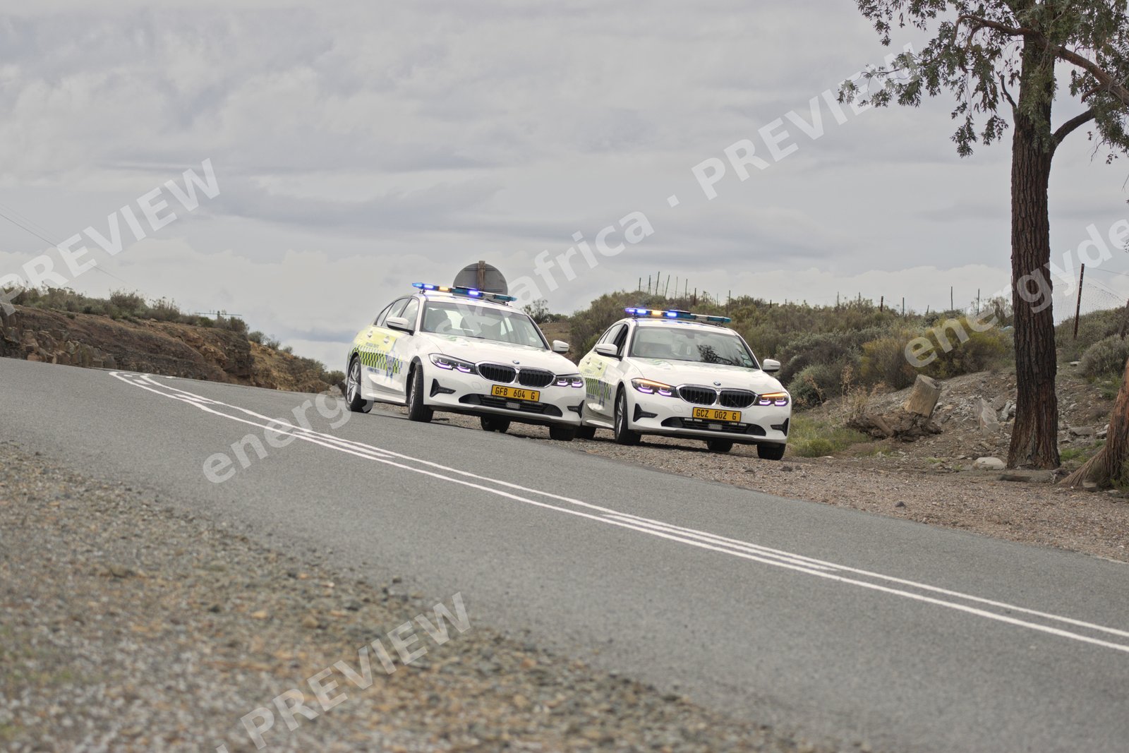 Abnormal-load escort vehicles on a Karoo road, Sutherland