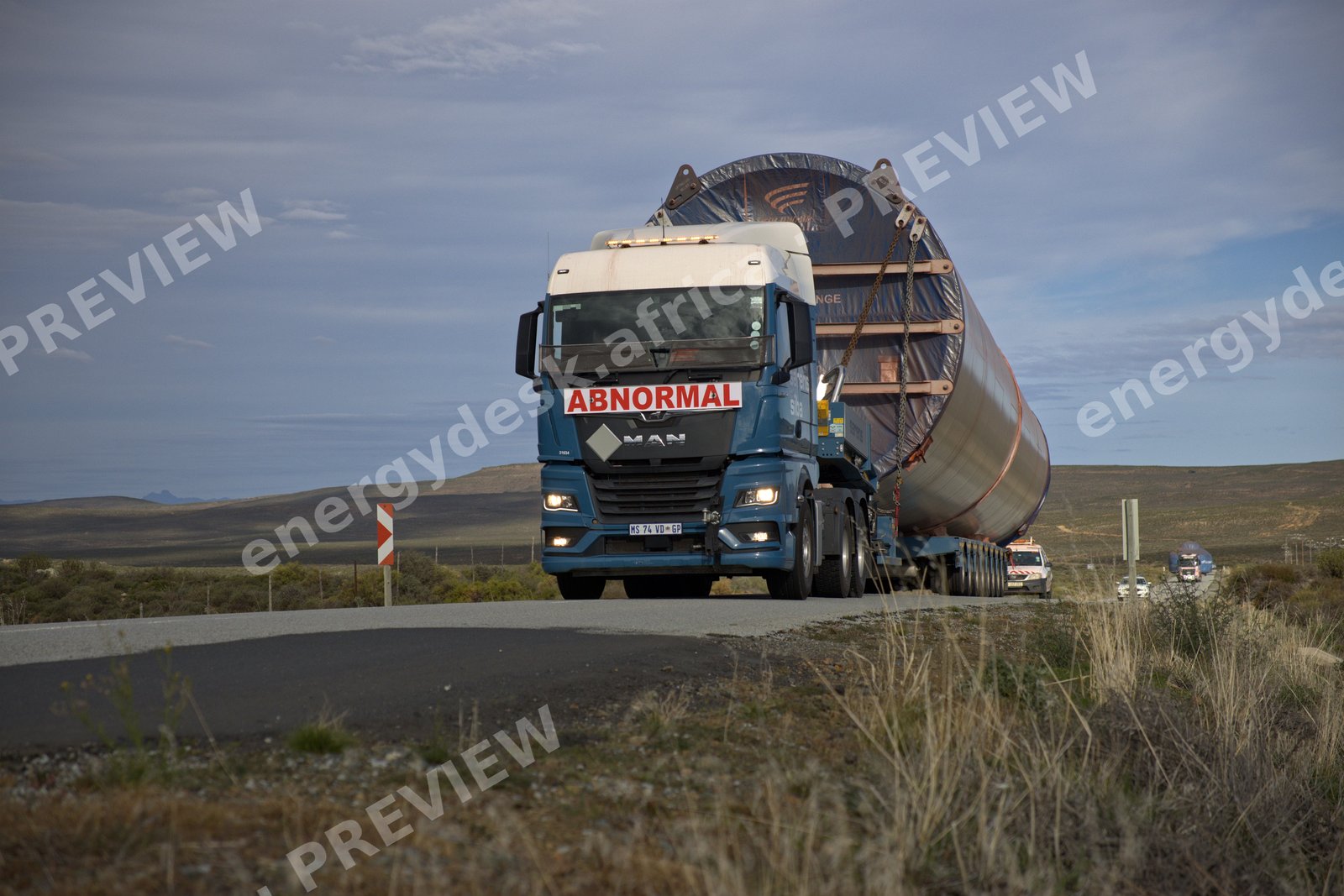 Abnormal-load convoy delivering a wind turbine tower section