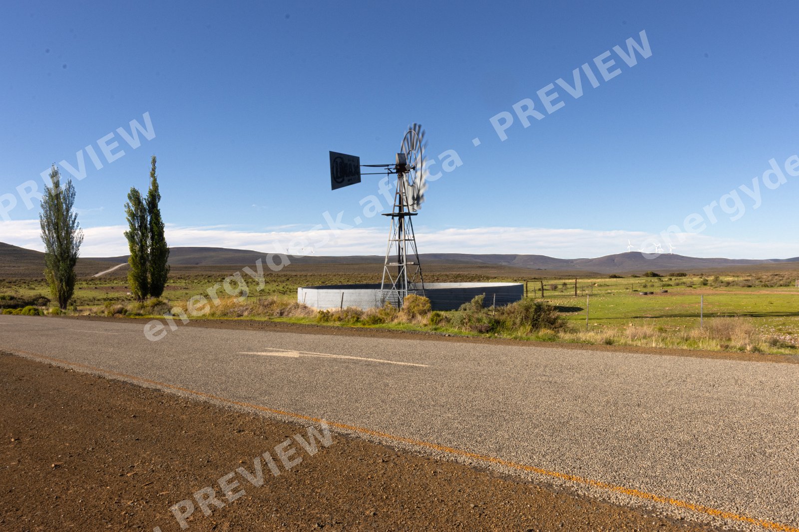 Farm windpump and reservoir on the road to Sutherland