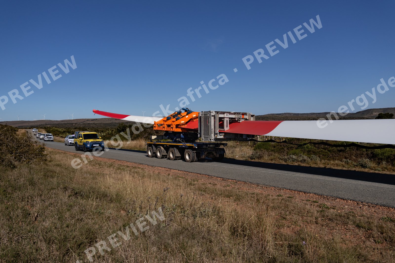 Red-tipped turbine blade and escort convoy en route to Wind Garden Wind Farm